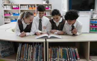 A photo showing students Blessed Sacrament Catholic Primary School Clifton Gardens reading in the library and on their way to 2025 NAPLAN results success