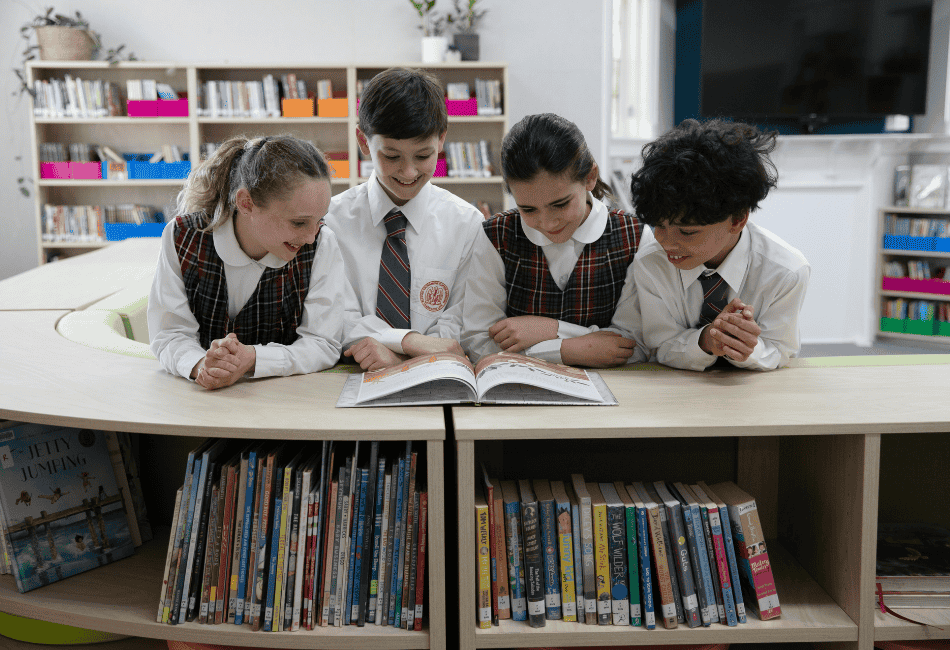 A photo showing students Blessed Sacrament Catholic Primary School Clifton Gardens reading in the library and on their way to 2025 NAPLAN results success